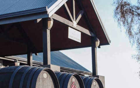 Winery entrance with large barrels and pavilion structure