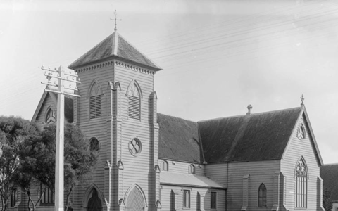 Historic timber church exterior with tower, black and white archival photograph