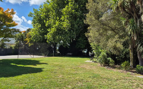 Open grassed reserve with trees and garden planting
