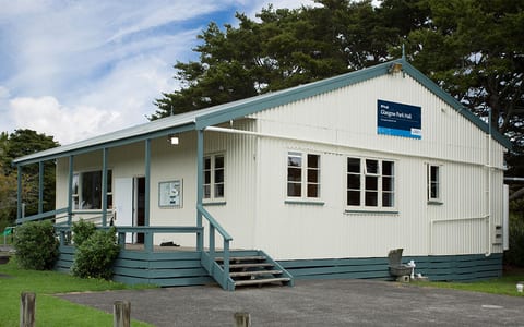 White weatherboard community hall with covered entrance steps