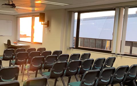 Informal seating area with small tables and harbour view