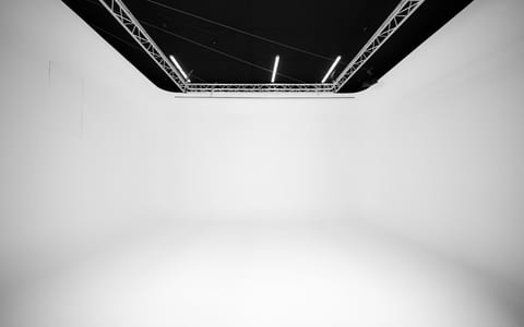 Empty white cyclorama studio with lighting truss overhead