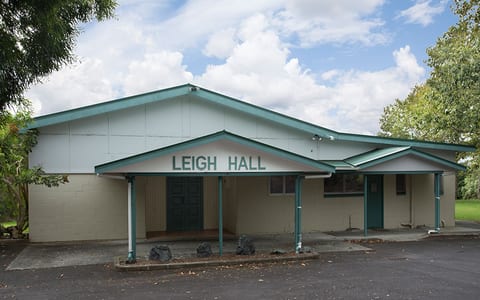 Single-storey hall with Leigh Hall signage and covered entry