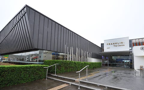 Franklin: The Centre building with angular dark metal cladding and glazed entry