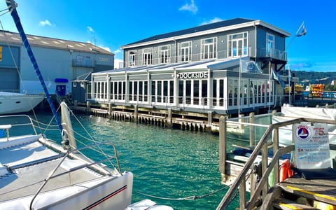 Dockside restaurant building over the water with boats moored alongside