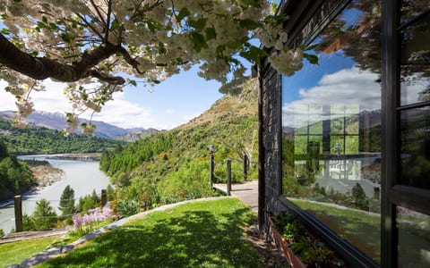 Garden terrace with a blossom tree overhanging the building and views to the river and mountains
