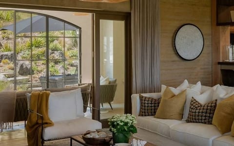 Rendered stone villa exterior with terrace seating and garden