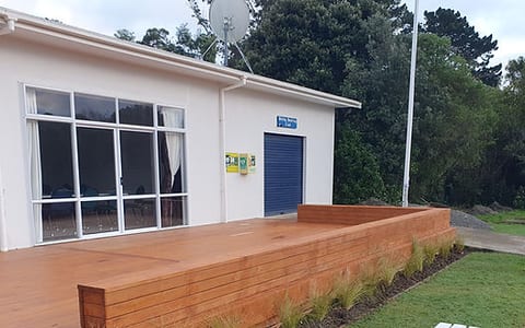 Club building with timber deck, garden bed, and bench seating