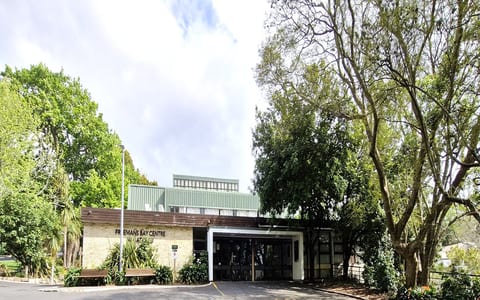 Brick and weatherboard community centre building surrounded by trees