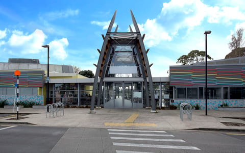 Arts centre with angular entry canopy and colourful facade panels