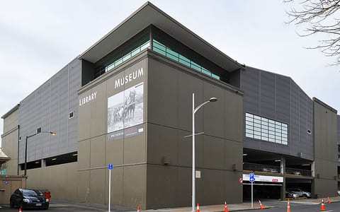 Multi-storey library and museum building exterior on street corner