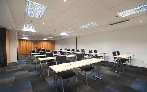 Meeting room with classroom table layout and stacked chairs