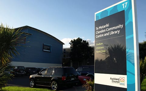 Community centre exterior with signage pylon in carpark