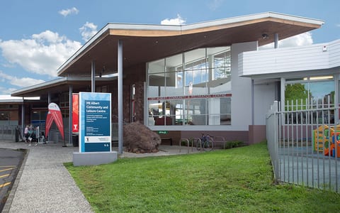 Community and leisure centre entrance with canopy, signage and landscaping