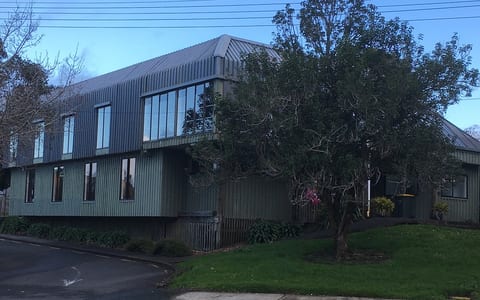 Two-storey corrugated metal clad hall building on a street corner