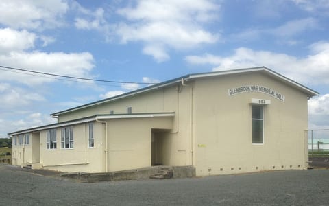 Cream rendered war memorial hall building with gable roof