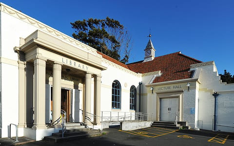 Heritage library and lecture hall building with classical columns and clock tower