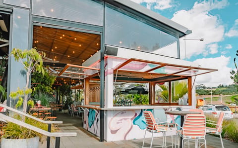 Outdoor bar and terrace area with colourful mural and seating