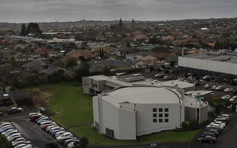 Aerial view of large church building with car parks in suburban setting