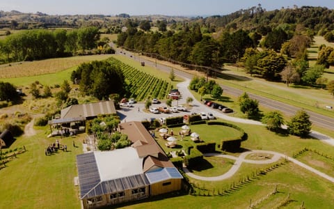 Aerial view of winery venue and vineyards with car park and marquee