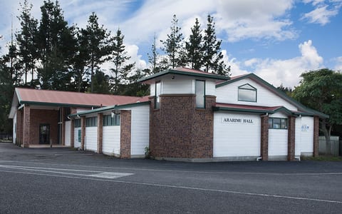 Brick and weatherboard community hall exterior with name signage