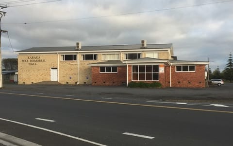 Two-storey brick war memorial hall building beside road