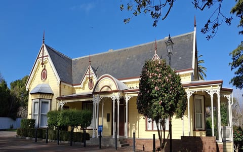 Victorian villa with yellow weatherboard and ornate gabled roofline