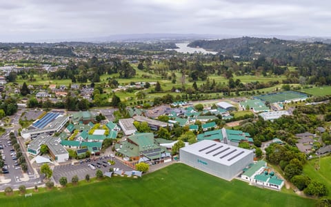 Aerial view of large school campus with sports fields and buildings