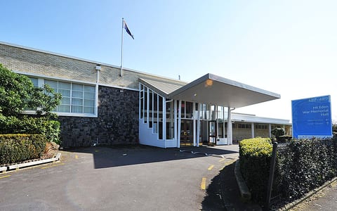 Mid-century civic hall exterior with canopy entrance and signage
