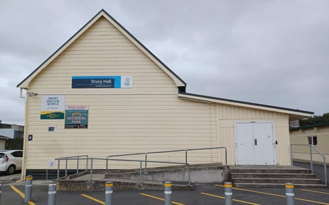 Hall front entrance with access ramp, steps and signage