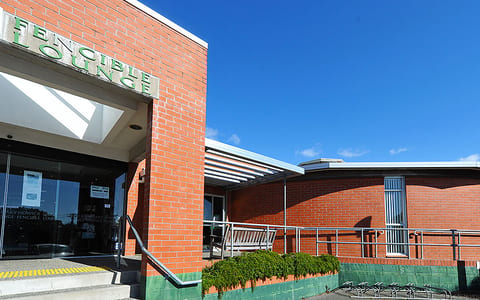Brick library building with Fencible Lounge signage and steps at entrance