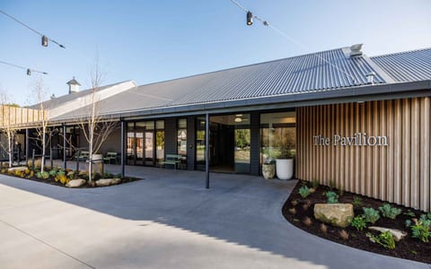 The Pavilion building entrance with corrugated roof and timber slat cladding