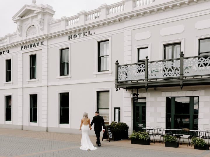 White heritage hotel facade with ornate balcony on the Queenstown waterfront