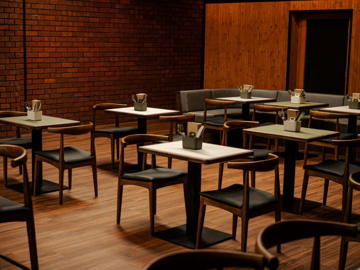Brick-walled dining room with timber-top tables, curved chairs and exposed brick feature wall