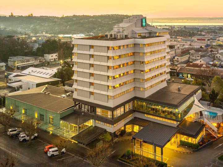 Aerial view of multi-storey hotel building in town centre at dusk