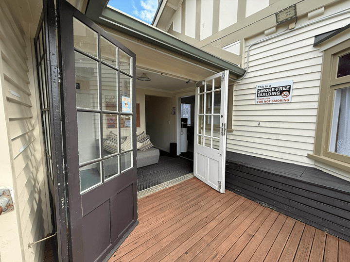 Outdoor timber deck accessed through French doors of timber building
