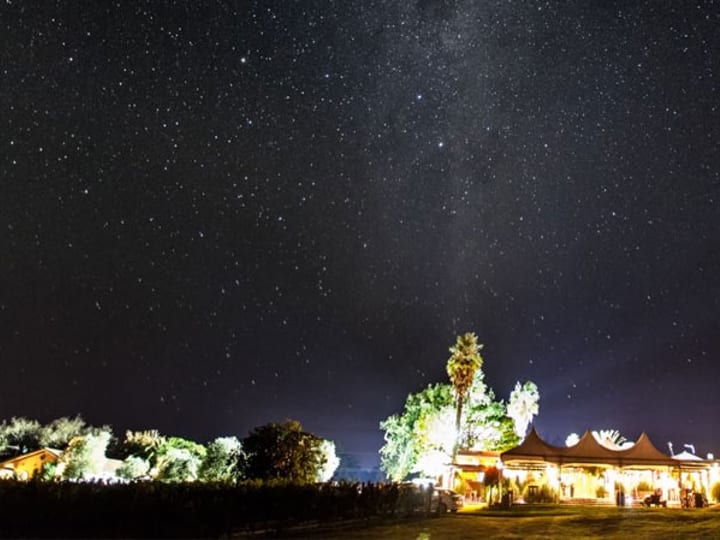 Winery venue lit up at night under a clear starry sky