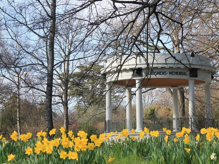 Neoclassical rotunda bandstand surrounded by daffodils and bare trees
