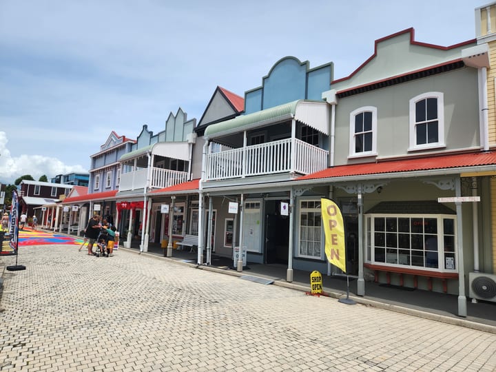 Historic building row with varied storefronts on paved street