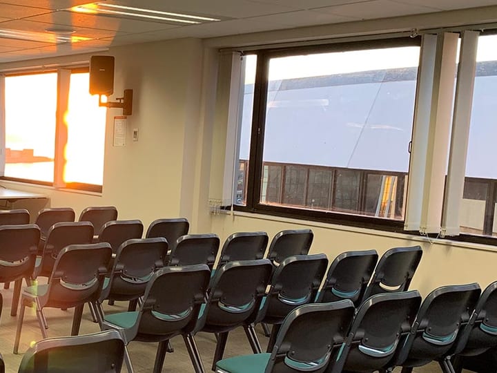 Informal seating area with small tables and harbour view