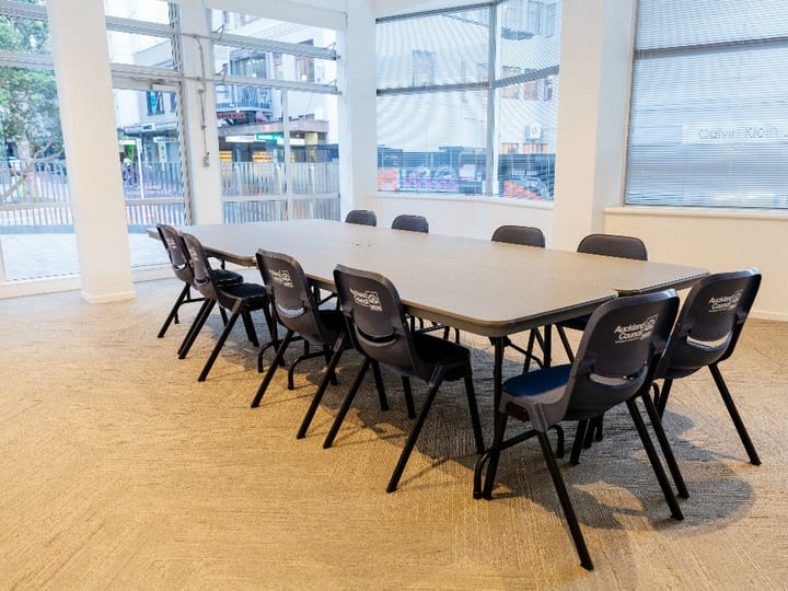 Small meeting room with large windows, boardroom table and Auckland Council branded chairs
