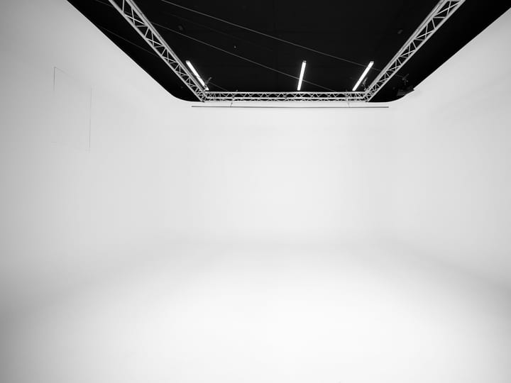 Empty white cyclorama studio with lighting truss overhead