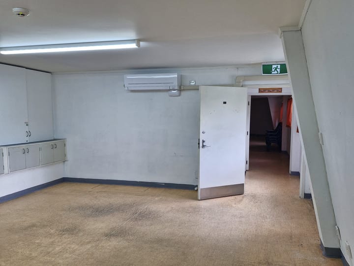 Meeting room with carpet, whiteboard, timber doors and highlight windows