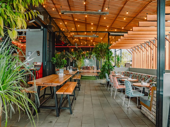 Casual dining area with mixed seating, shelving and large windows