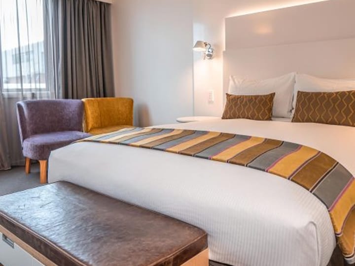 Accessible hotel room with double bed and armchairs