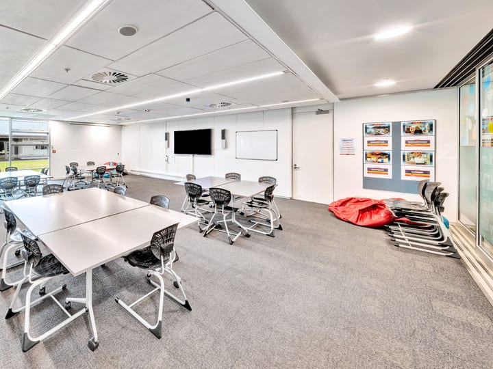 Flexible meeting room with tables, chairs and whiteboard