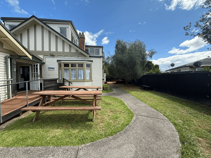 Side garden area with deck, picnic tables and timber fence