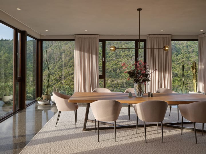 Open-plan living area with modular sofa, polished concrete floors and bifold doors to garden
