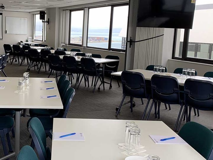 Conference room with tables and chairs set for a meeting