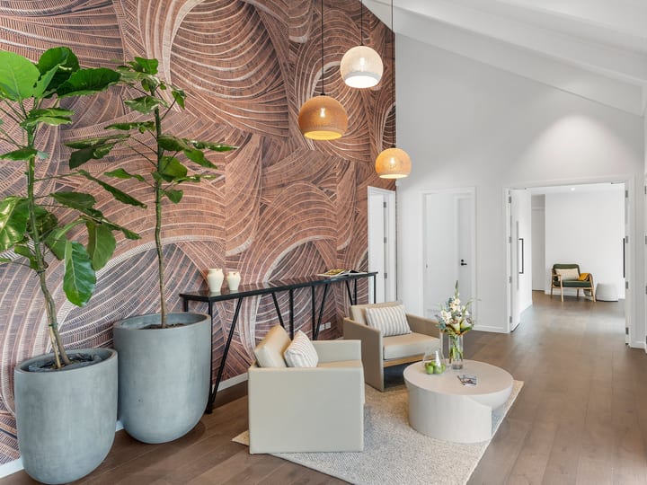 Lodge foyer with botanical wallpaper feature wall, pendant lights and seating